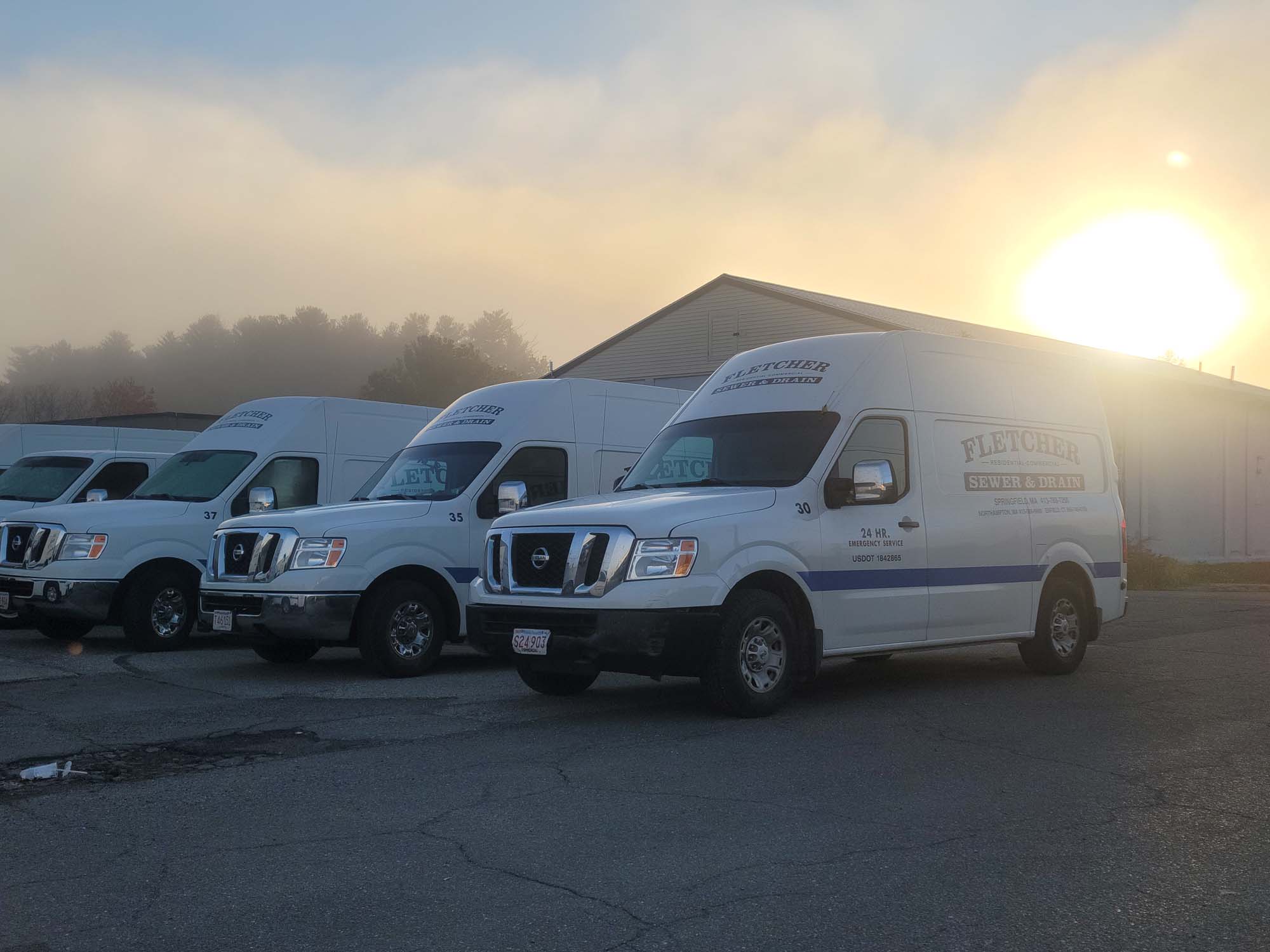 Fletcher Sewer & Drain work truck showing 24 hour emergency service for sewer and drain services with a blue sky in the background